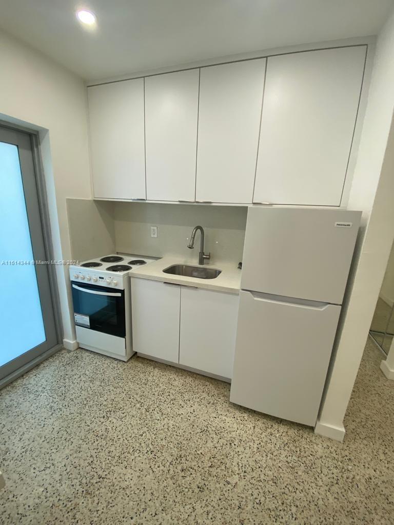 Santa Clara Miami, FL 33127 - Photo 6 of 11 a kitchen with a sink and a refrigerator