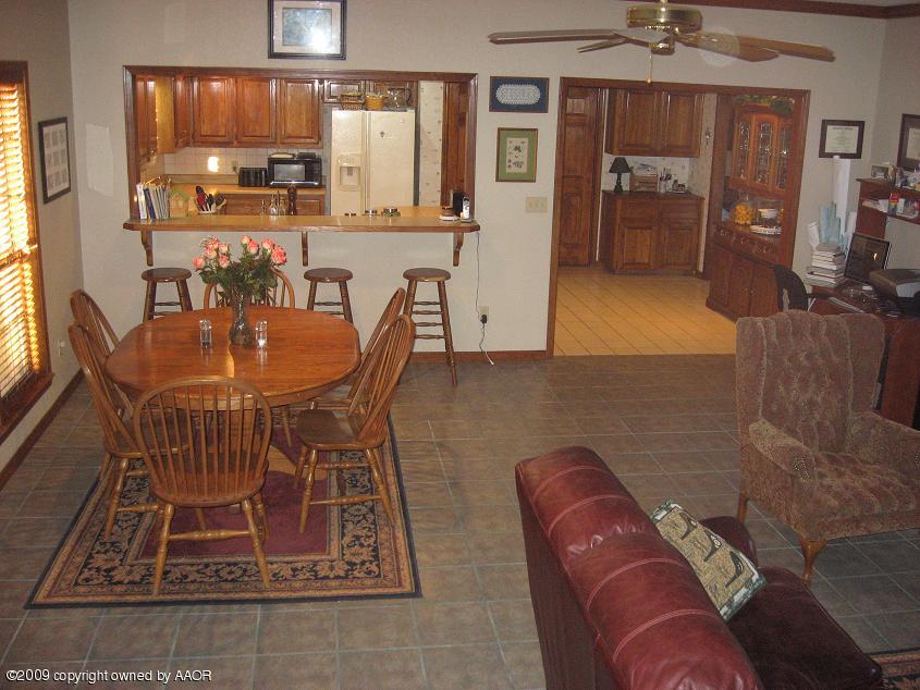8308 Ranier Drive Amarillo, TX 79110 - Photo 8 of 16 a living room with furniture a chandelier and kitchen view