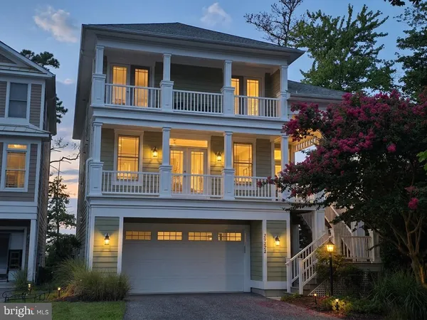 a kitchen with stainless steel appliances granite countertop wooden floors wooden cabinets a stove and a center island