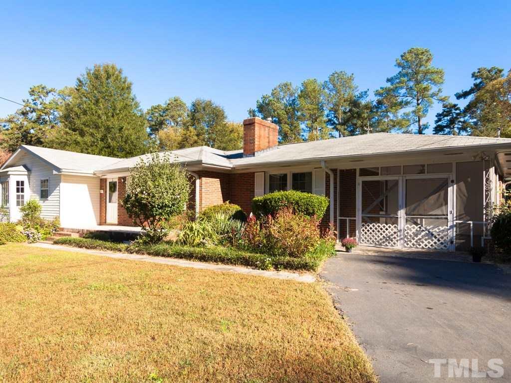 331 Golf Course Drive Raleigh, NC 27610 - Photo 2 of 25 a front view of a house with a garden and porch