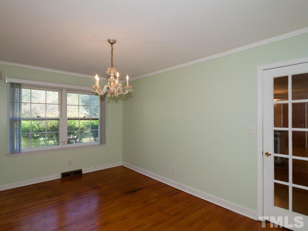 331 Golf Course Drive Raleigh, NC 27610 - Photo 12 of 25 a view of an empty room with wooden floor and a window