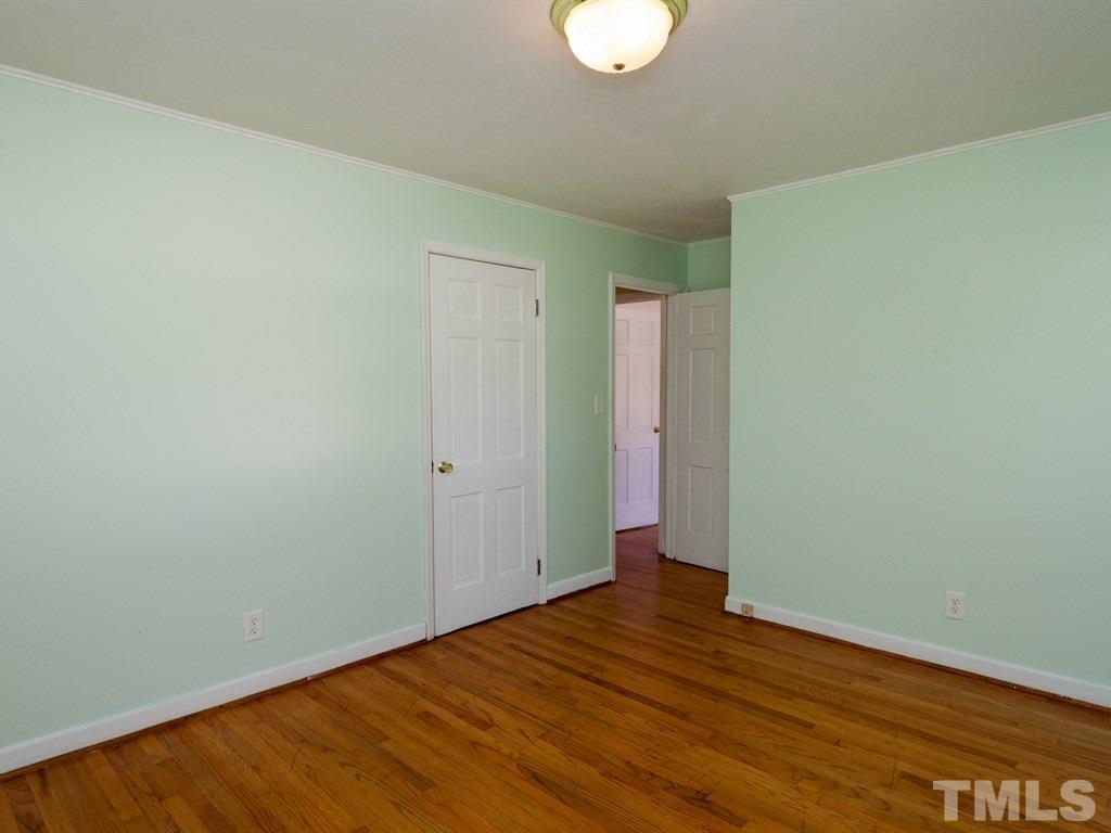 331 Golf Course Drive Raleigh, NC 27610 - Photo 13 of 25 a view of an empty room with wooden floor
