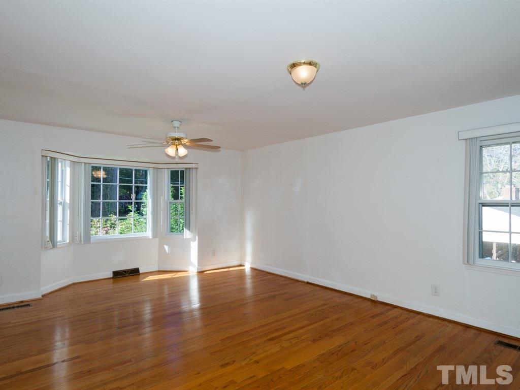 331 Golf Course Drive Raleigh, NC 27610 - Photo 15 of 25 a view of empty room with wooden floor and fan