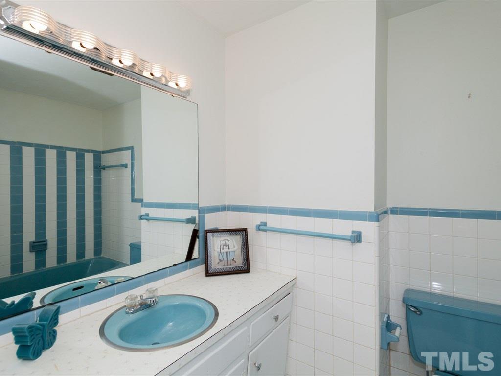 331 Golf Course Drive Raleigh, NC 27610 - Photo 21 of 25 a bathroom with a sink and a mirror