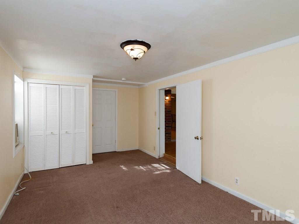 331 Golf Course Drive Raleigh, NC 27610 - Photo 22 of 25 an empty room with a empty space and windows