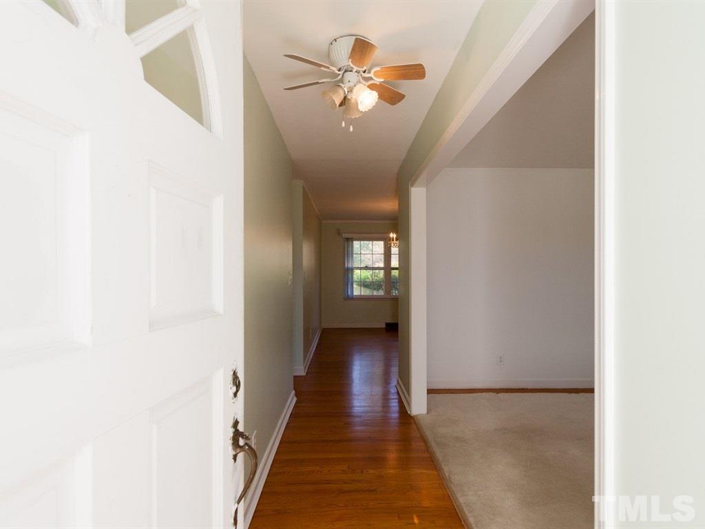 331 Golf Course Drive Raleigh, NC 27610 - Photo 4 of 25 a view of a hallway with a chandelier
