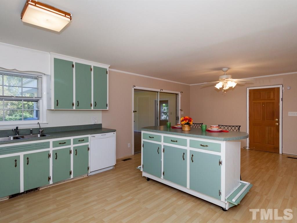 331 Golf Course Drive Raleigh, NC 27610 - Photo 5 of 25 a kitchen with a sink cabinets and wooden floor