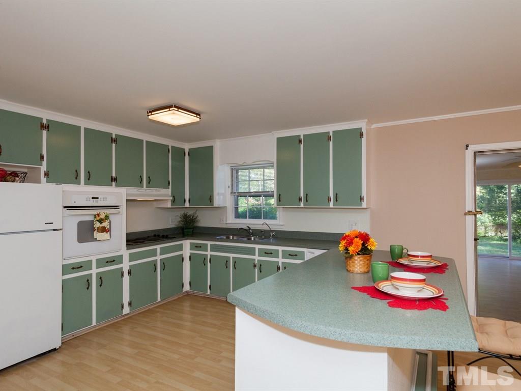 331 Golf Course Drive Raleigh, NC 27610 - Photo 6 of 25 a kitchen with stainless steel appliances granite countertop a sink and cabinets