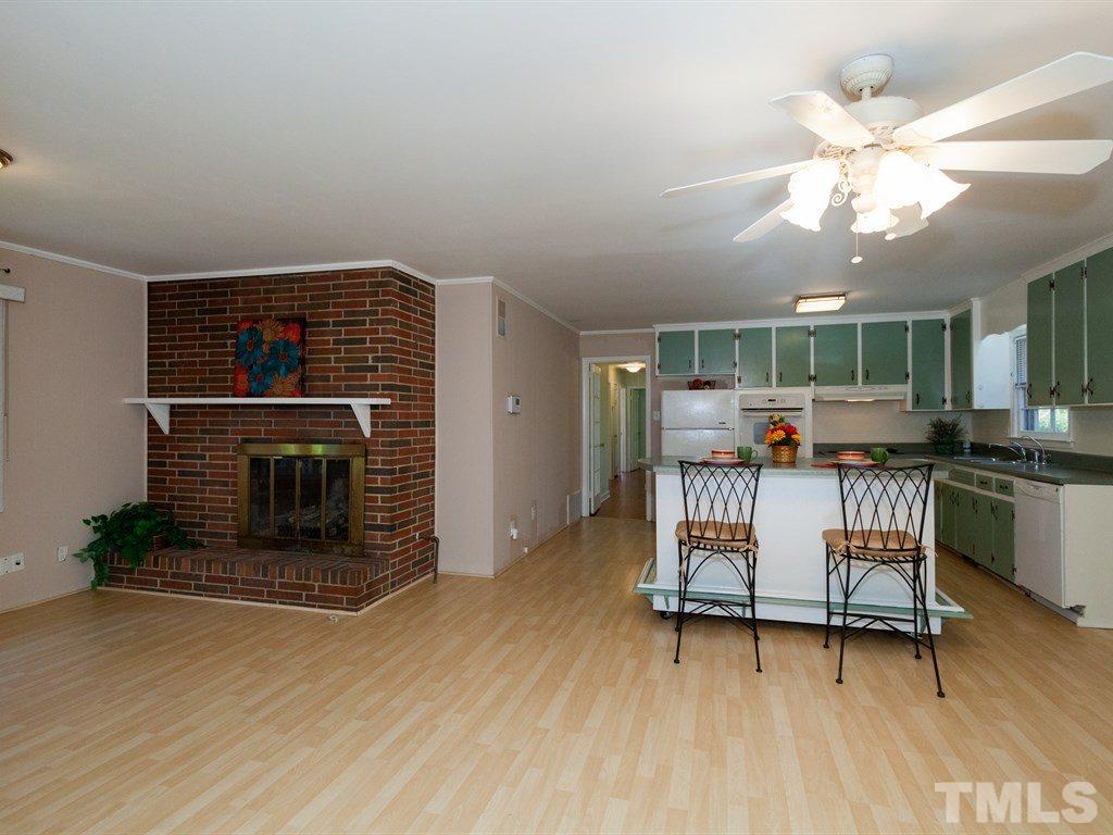 331 Golf Course Drive Raleigh, NC 27610 - Photo 8 of 25 a living room with furniture and a fireplace