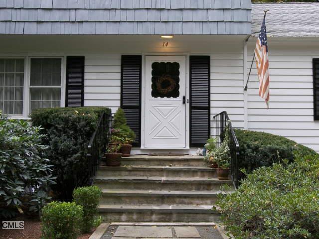 14 St Johns Road Wilton, CT 06897 - Photo 1 of 1 a front view of a house with a garden