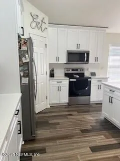 a view of a dining room with wooden floor