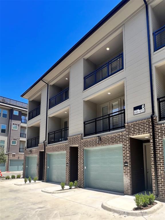 4020 McEwen Road, Unit 9123 Farmers Branch, TX 75244 - Photo 9 of 20 View of building exterior with driveway and an attached garage