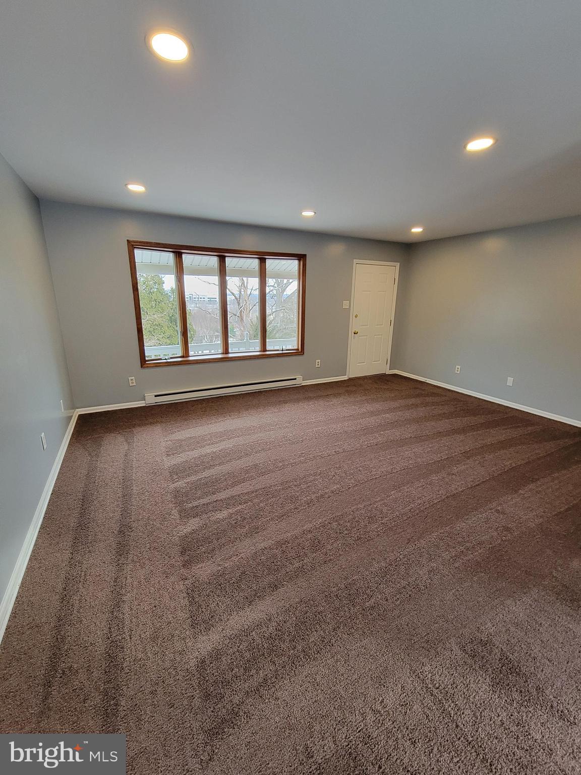 320 Troutman Road Collegeville, PA 19426 - Photo 3 of 21 an empty room with wooden floor and windows
