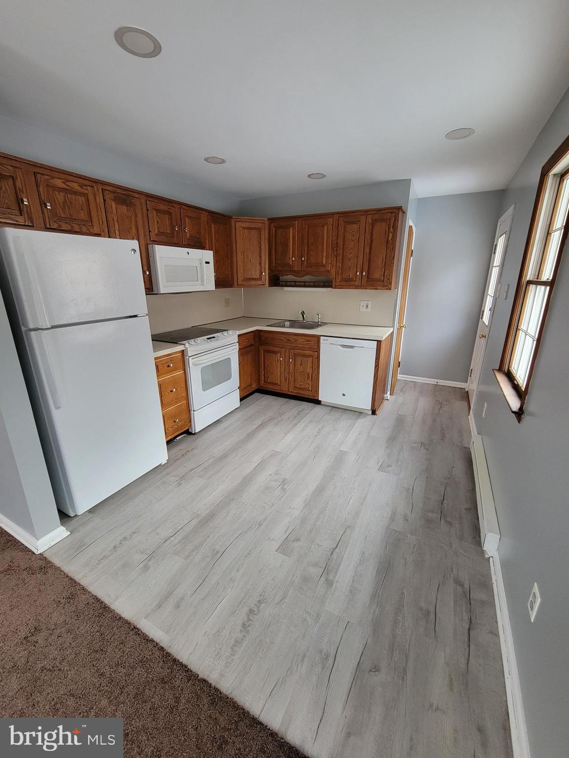 320 Troutman Road Collegeville, PA 19426 - Photo 6 of 21 a kitchen with stainless steel appliances wooden floors and view living room