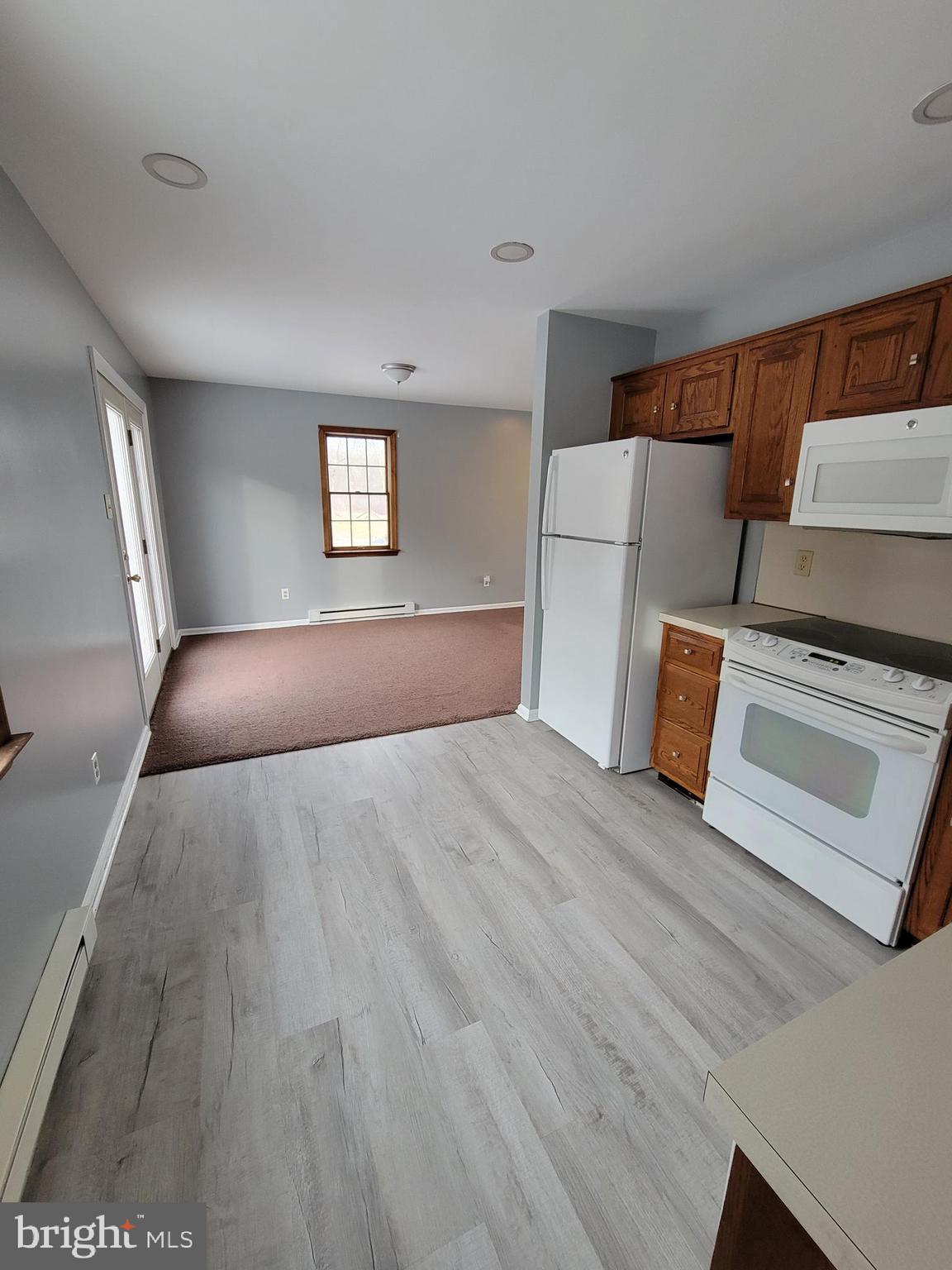 320 Troutman Road Collegeville, PA 19426 - Photo 7 of 21 a view of an empty room with wooden floor and a window