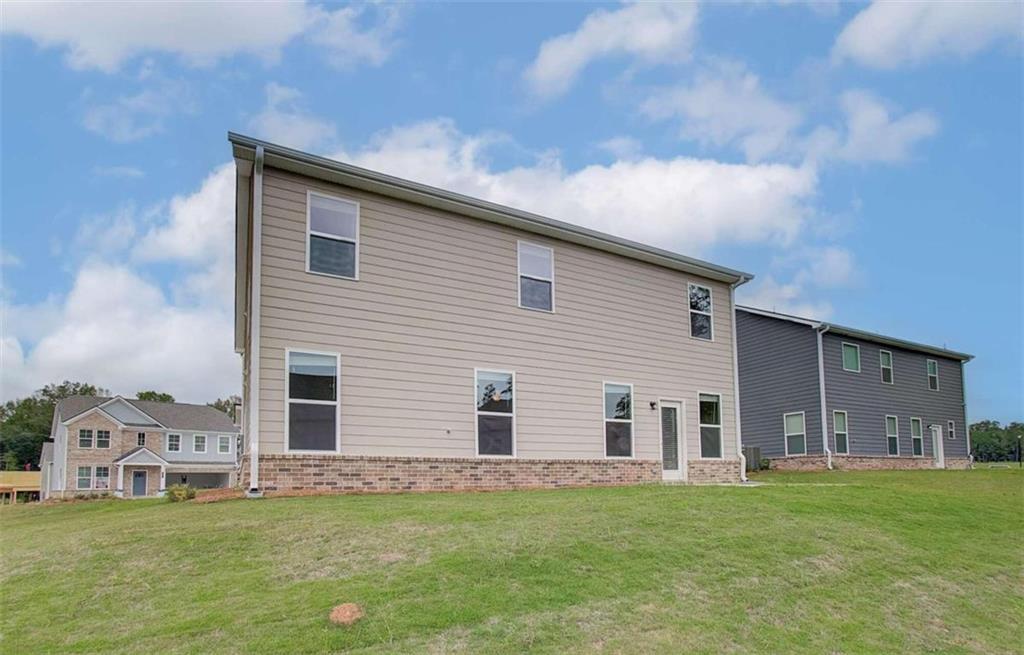 140 St Anne's Place Covington, GA 30016 - Photo 32 of 33 a backyard of a house with table and chairs