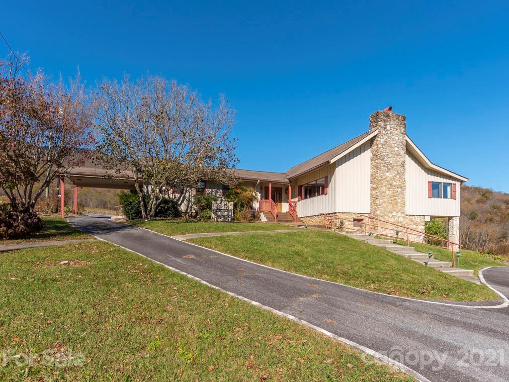 566 Walker Road Waynesville, NC 28786 - Photo 1 of 28 a front view of a house with a yard and garage