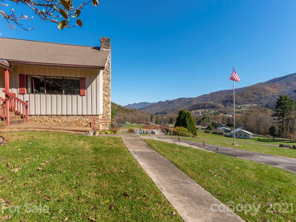 566 Walker Road Waynesville, NC 28786 - Photo 2 of 28 a view of a house with a yard and a large tree