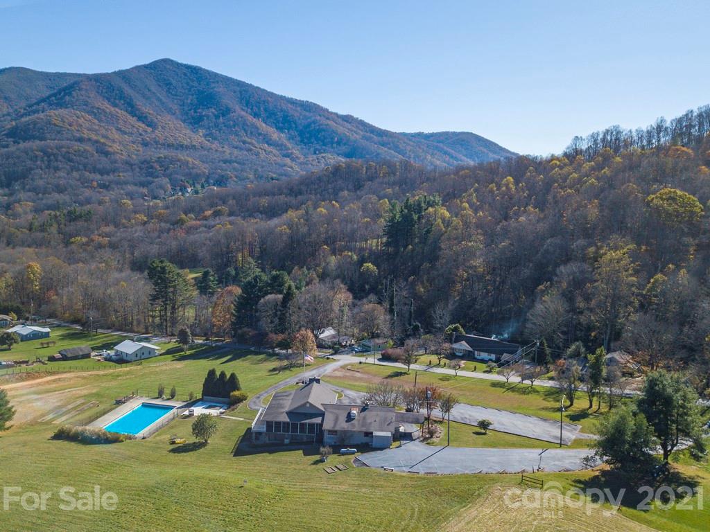 566 Walker Road Waynesville, NC 28786 - Photo 28 of 28 a view of a swimming pool with mountains and grass