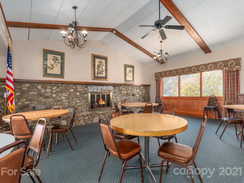 566 Walker Road Waynesville, NC 28786 - Photo 5 of 28 a view of a dining room with furniture window and wooden floor