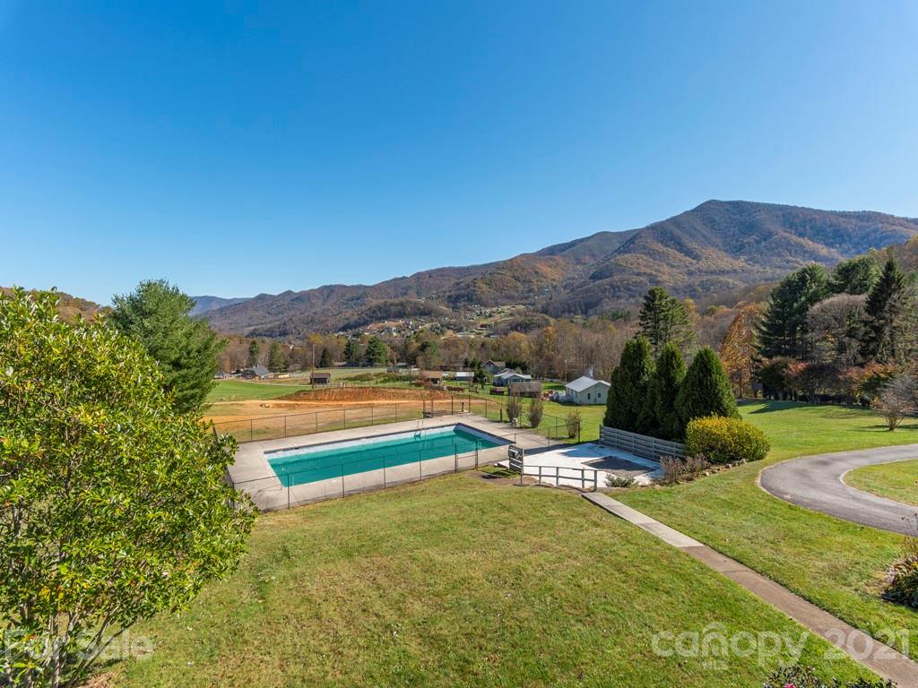 566 Walker Road Waynesville, NC 28786 - Photo 10 of 28 a view of swimming pool with a garden and mountain view