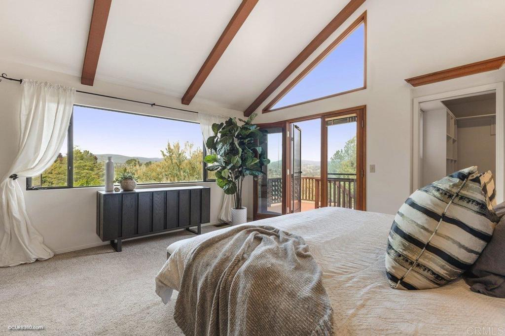602 Sereno View Road Encinitas, CA 92024 - Photo 12 of 56 a bed sitting in a bedroom next to a large window