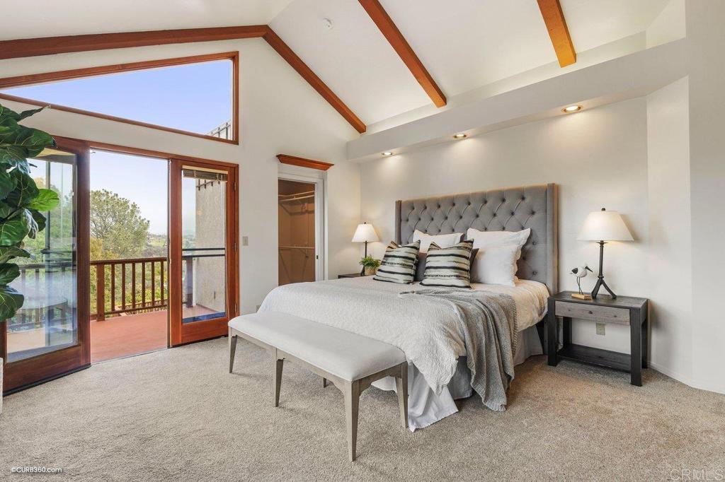 602 Sereno View Road Encinitas, CA 92024 - Photo 15 of 56 a spacious bedroom with a bed and a large window