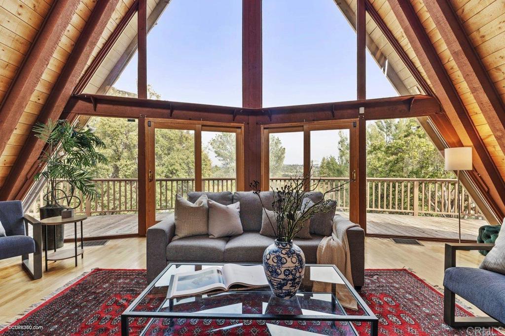 602 Sereno View Road Encinitas, CA 92024 - Photo 2 of 56 a living room with furniture and a floor to ceiling window