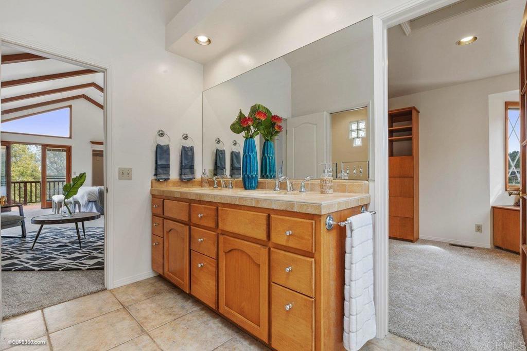 602 Sereno View Road Encinitas, CA 92024 - Photo 21 of 56 a spacious bathroom with a double vanity sink and a mirror