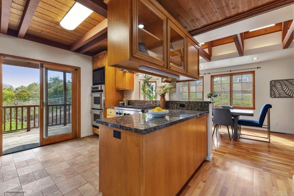 602 Sereno View Road Encinitas, CA 92024 - Photo 27 of 56 a dining hall with stainless steel appliances granite countertop a stove and cabinets