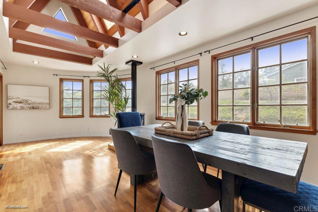 602 Sereno View Road Encinitas, CA 92024 - Photo 30 of 56 a view of a dining room with furniture large windows and wooden floor