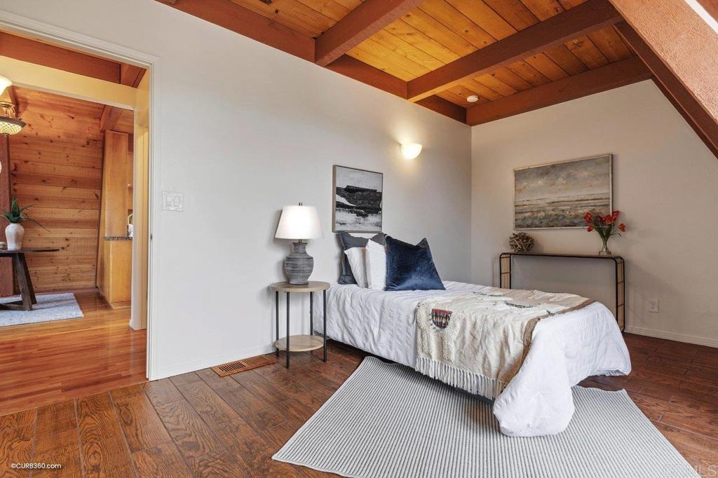 602 Sereno View Road Encinitas, CA 92024 - Photo 34 of 56 a bedroom with a bed and wooden floor