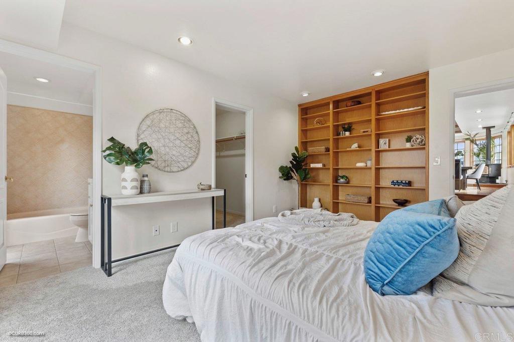 602 Sereno View Road Encinitas, CA 92024 - Photo 37 of 56 a bedroom with a large bed and a potted plant