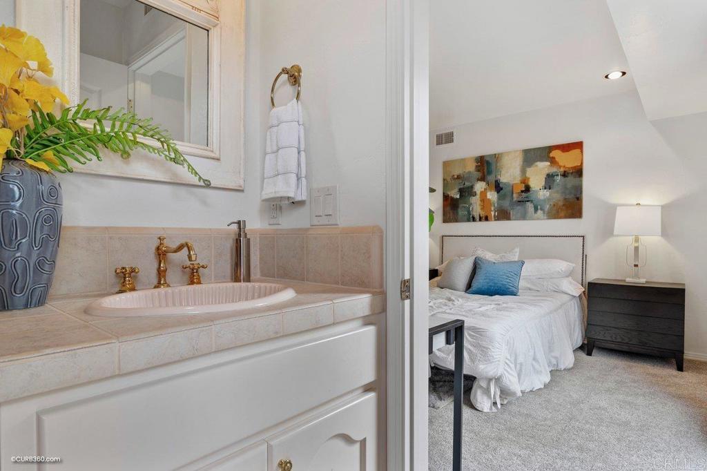 602 Sereno View Road Encinitas, CA 92024 - Photo 39 of 56 a bedroom with a bed and a painting on the wall