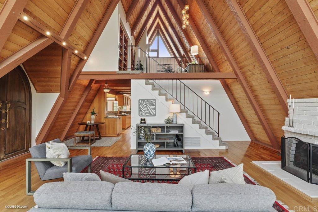 602 Sereno View Road Encinitas, CA 92024 - Photo 7 of 56 a living room with couches a fireplace with wooden floor