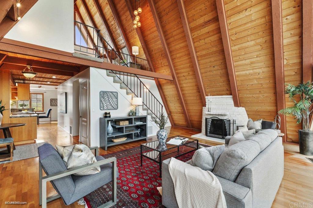 602 Sereno View Road Encinitas, CA 92024 - Photo 8 of 56 a living room with furniture a fireplace and a table