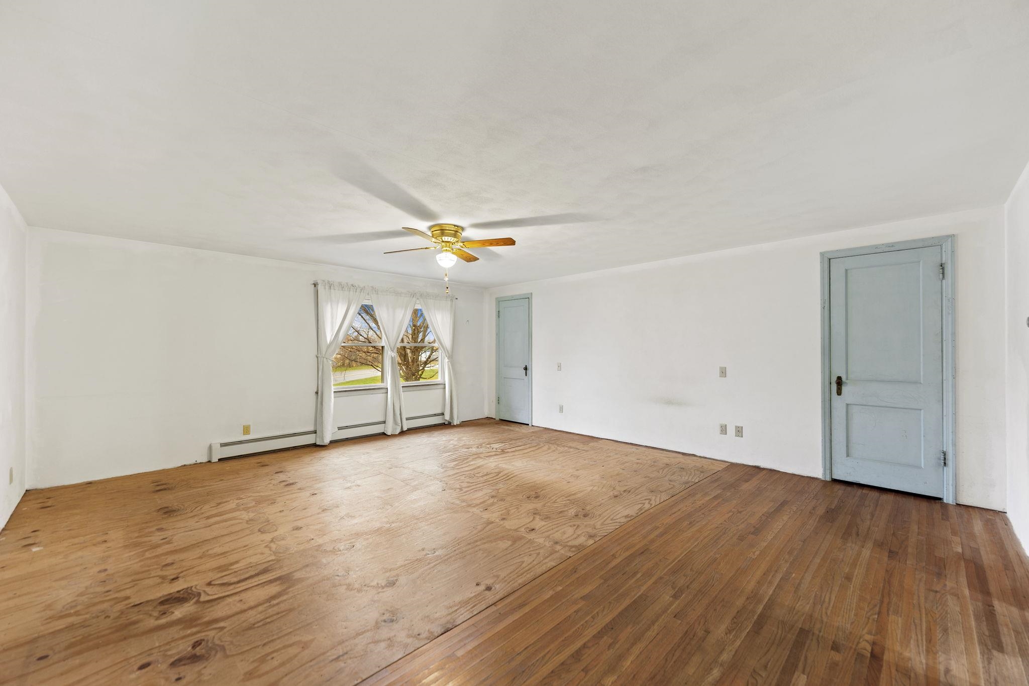 739 Elgin Street Cherry Valley, IL 61016 - Photo 11 of 41 an empty room with wooden floor and window