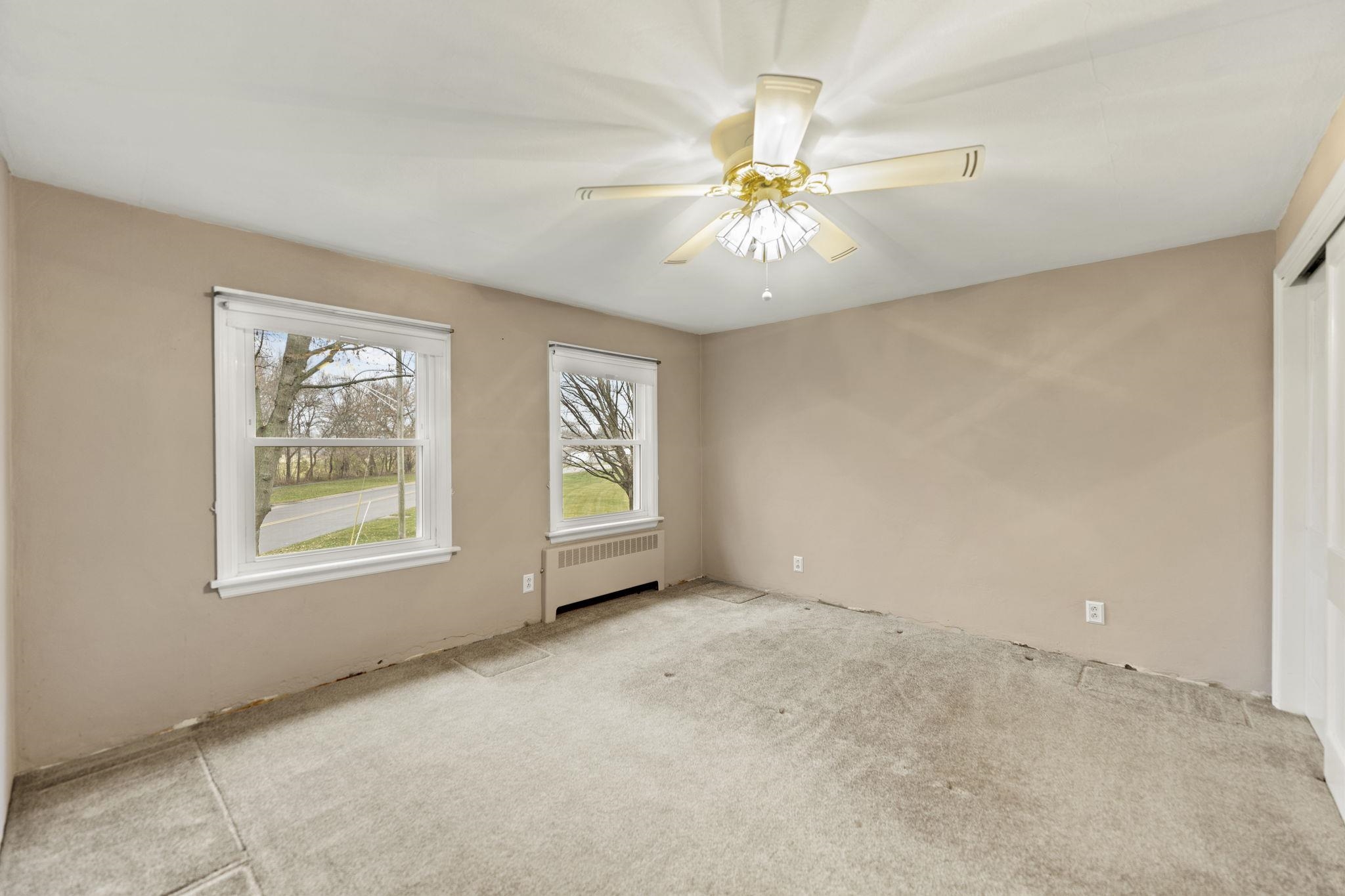 739 Elgin Street Cherry Valley, IL 61016 - Photo 15 of 41 an empty room with windows and fan