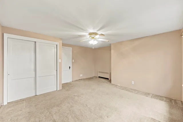 a view of an empty room with a ceiling fan