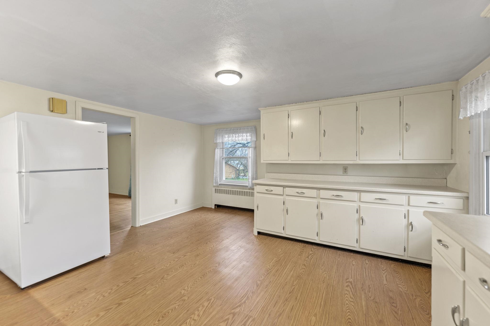 739 Elgin Street Cherry Valley, IL 61016 - Photo 31 of 41 a kitchen with granite countertop white cabinets and refrigerator