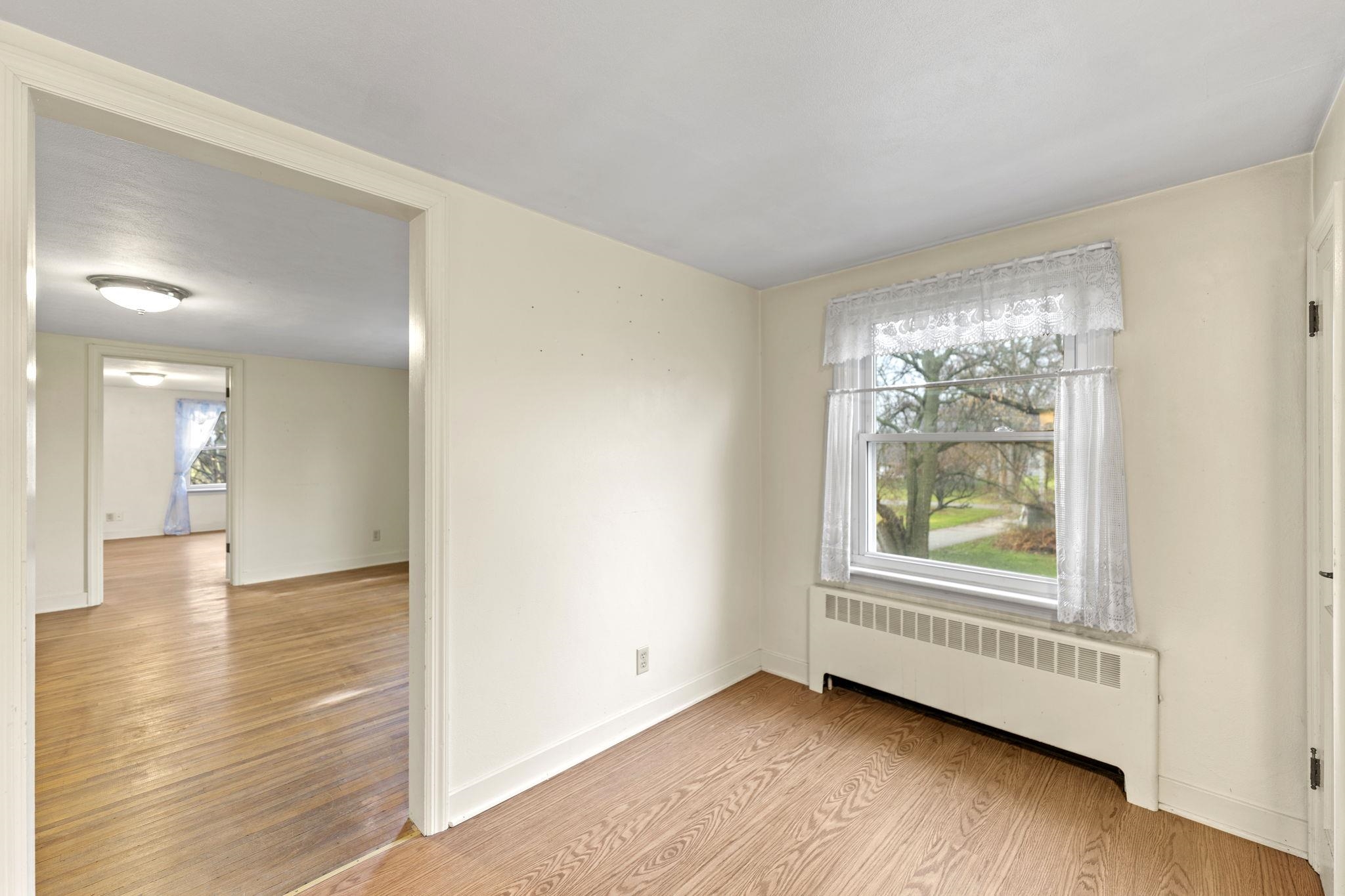739 Elgin Street Cherry Valley, IL 61016 - Photo 32 of 41 a view of an empty room with wooden floor and a window
