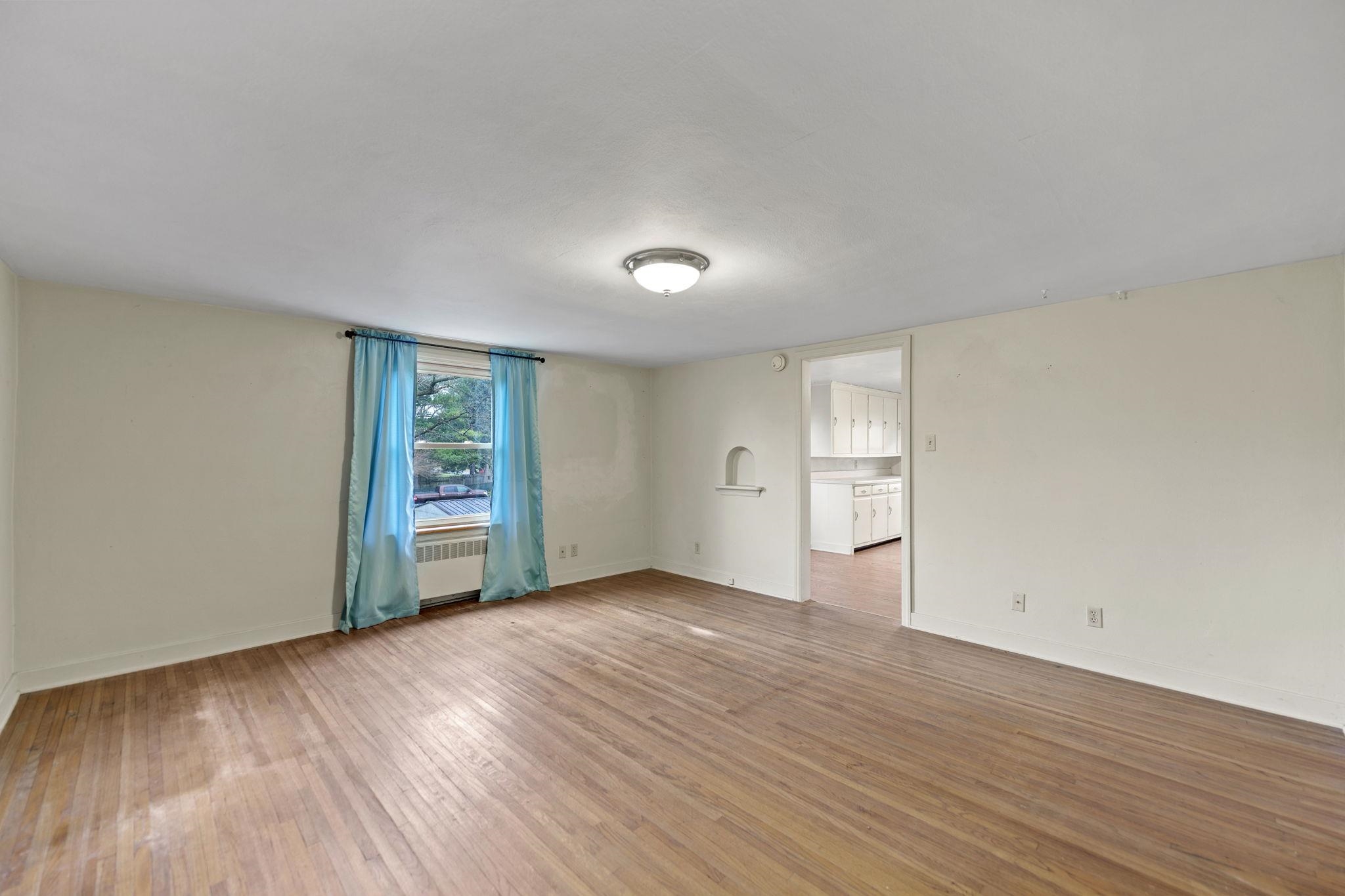 739 Elgin Street Cherry Valley, IL 61016 - Photo 33 of 41 an empty room with wooden floor and windows