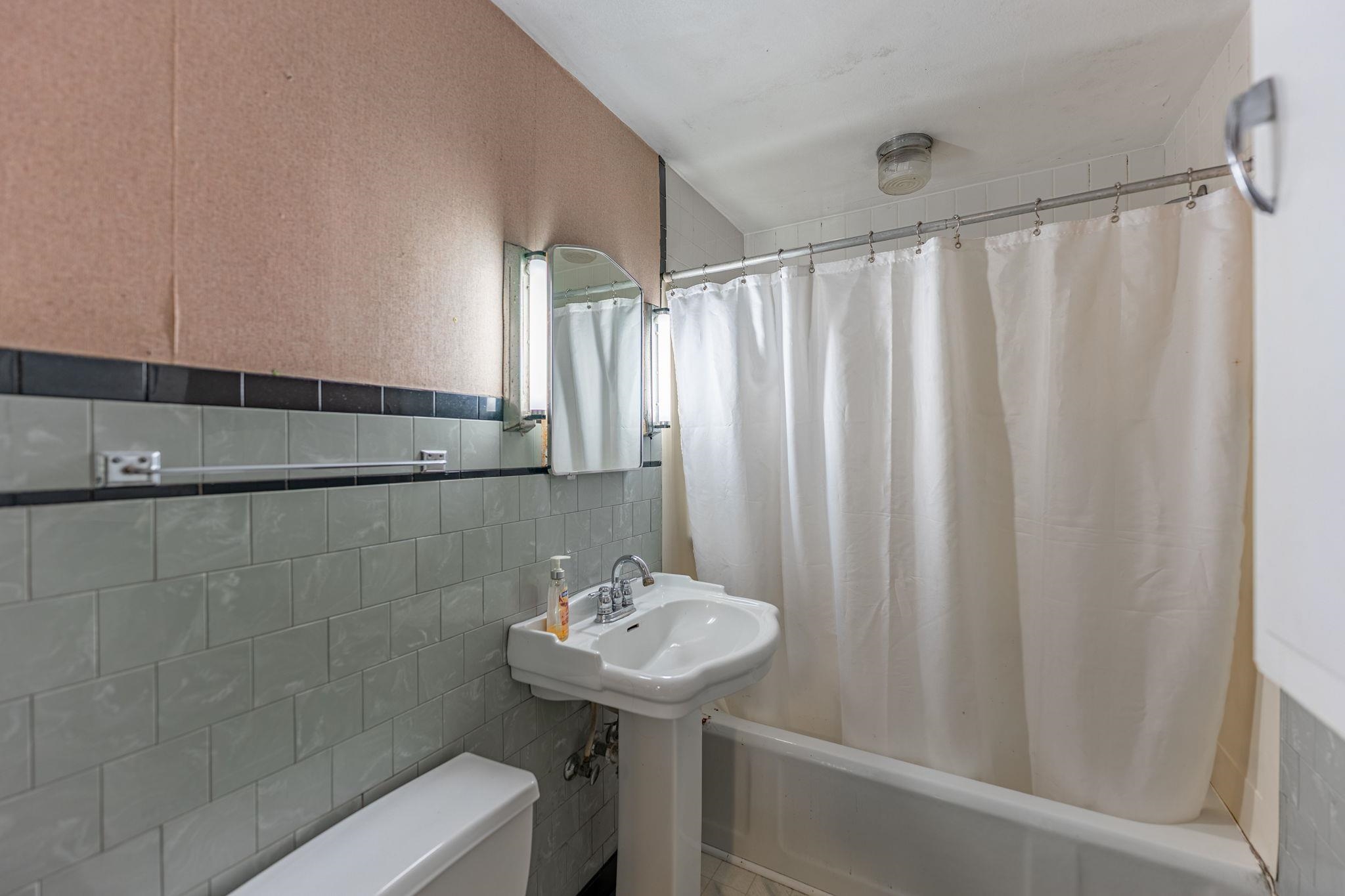 739 Elgin Street Cherry Valley, IL 61016 - Photo 35 of 41 a bathroom with a sink a mirror and a shower curtain