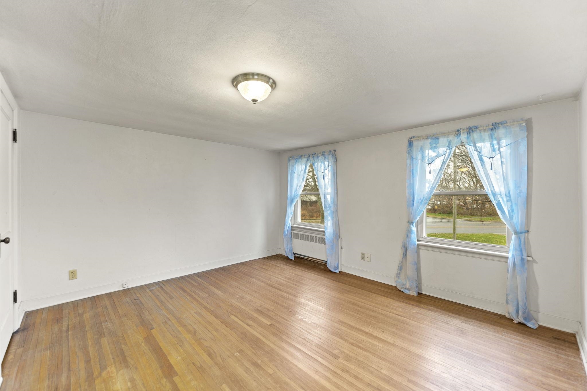 739 Elgin Street Cherry Valley, IL 61016 - Photo 36 of 41 an empty room with wooden floor and windows