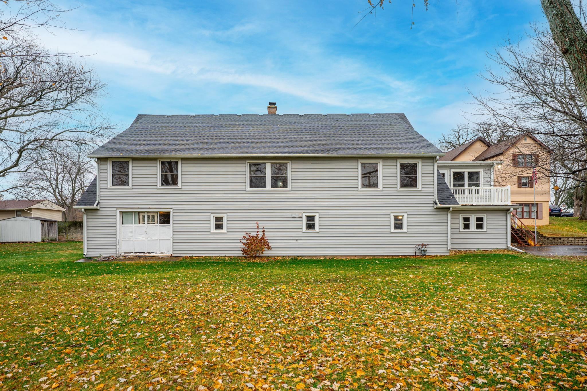 739 Elgin Street Cherry Valley, IL 61016 - Photo 39 of 41 a front view of a house with a garden and yard