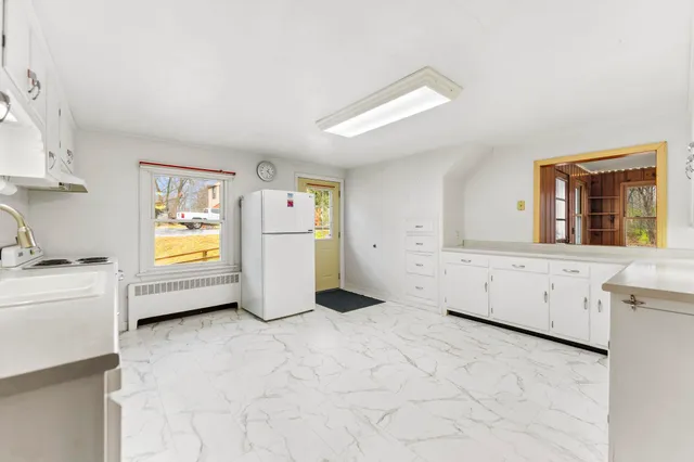 a kitchen with cabinets and window