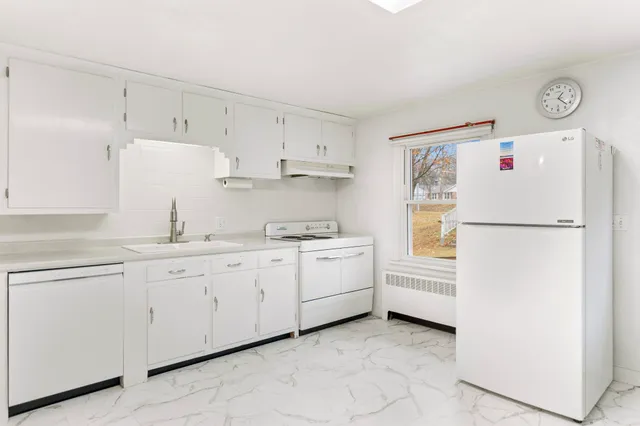 a white refrigerator freezer sitting inside of a kitchen