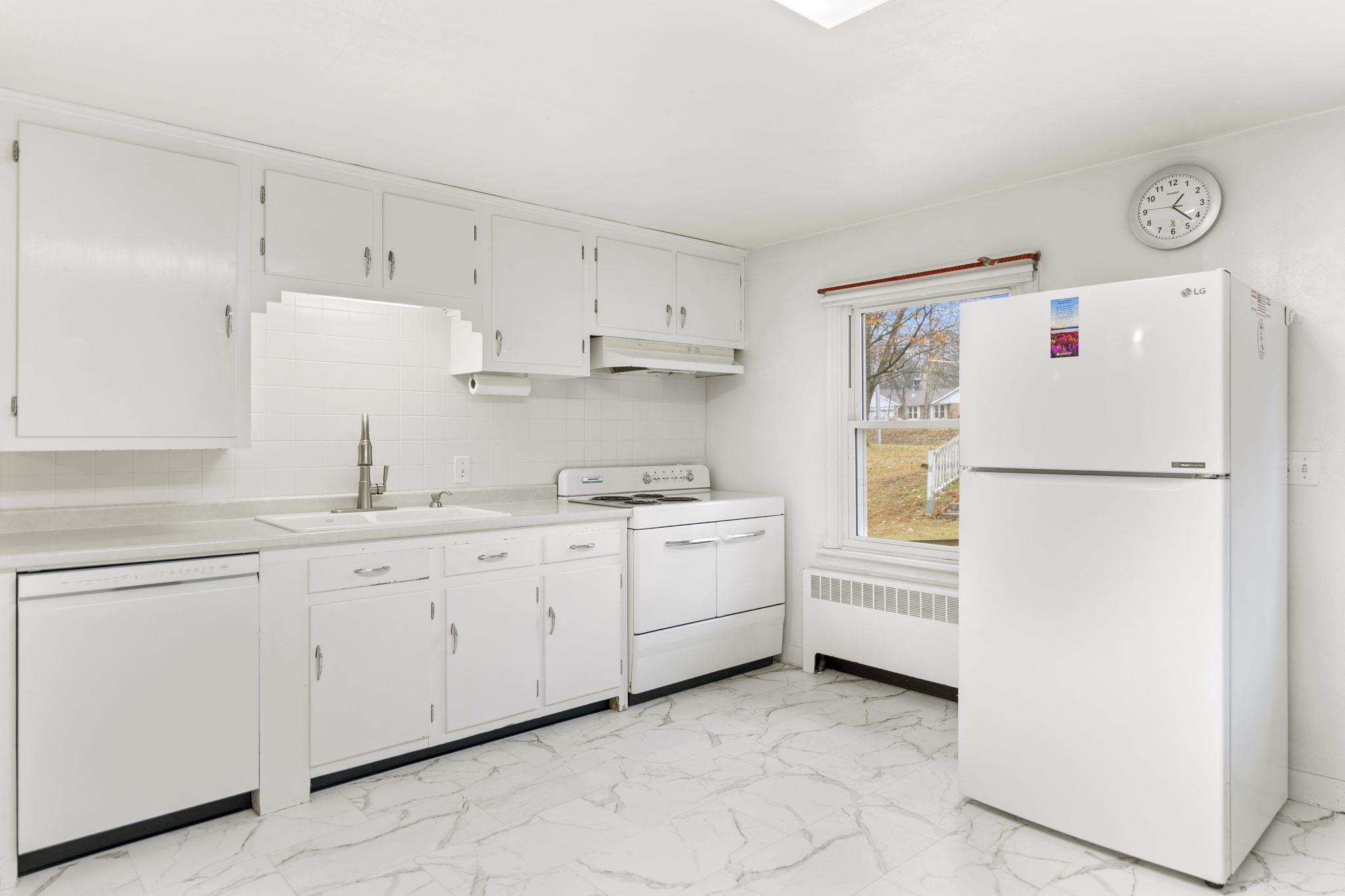 739 Elgin Street Cherry Valley, IL 61016 - Photo 7 of 41 a white refrigerator freezer sitting inside of a kitchen