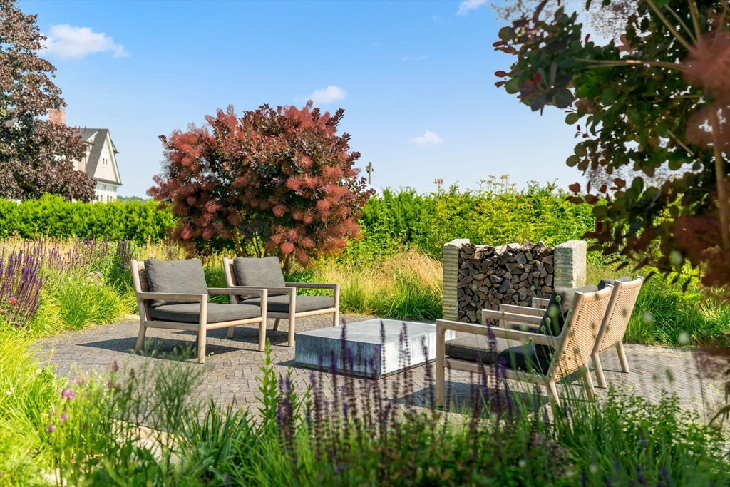 5 Redstone Lane Marblehead, MA 01945 - Photo 33 of 37 a chair and table sitting in backyard of house