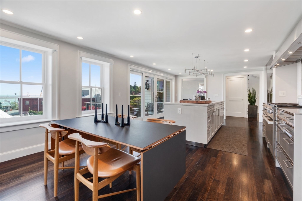 5 Redstone Lane Marblehead, MA 01945 - Photo 10 of 37 a open dining room with stainless steel appliances kitchen island granite countertop a table chairs and a refrigerator